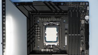 Intel Core i9 14900K CPU on a box and inside a motherboard socket.